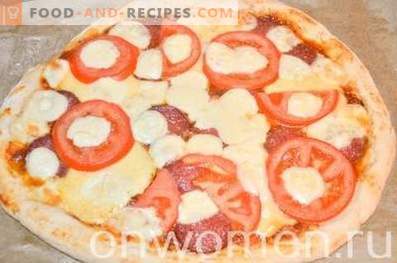 Pizza with salami and mozzarella on yeast dough