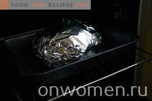 Chicken baked in foil in the oven entirely